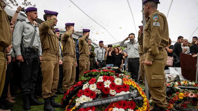 Israeli soldiers attend the funeral of a fellow soldier on November 1, 2023, in a military cemetery in Jerusalem.