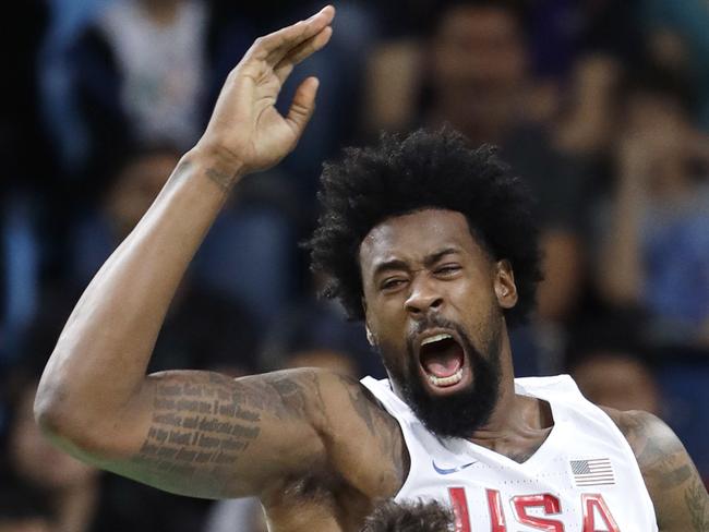 United States' DeAndre Jordan, top, reacts as he scores over Serbia's Nikola Kalinic during a men's basketball game at the 2016 Summer Olympics in Rio de Janeiro, Brazil, Friday, Aug. 12, 2016. (AP Photo/Eric Gay)