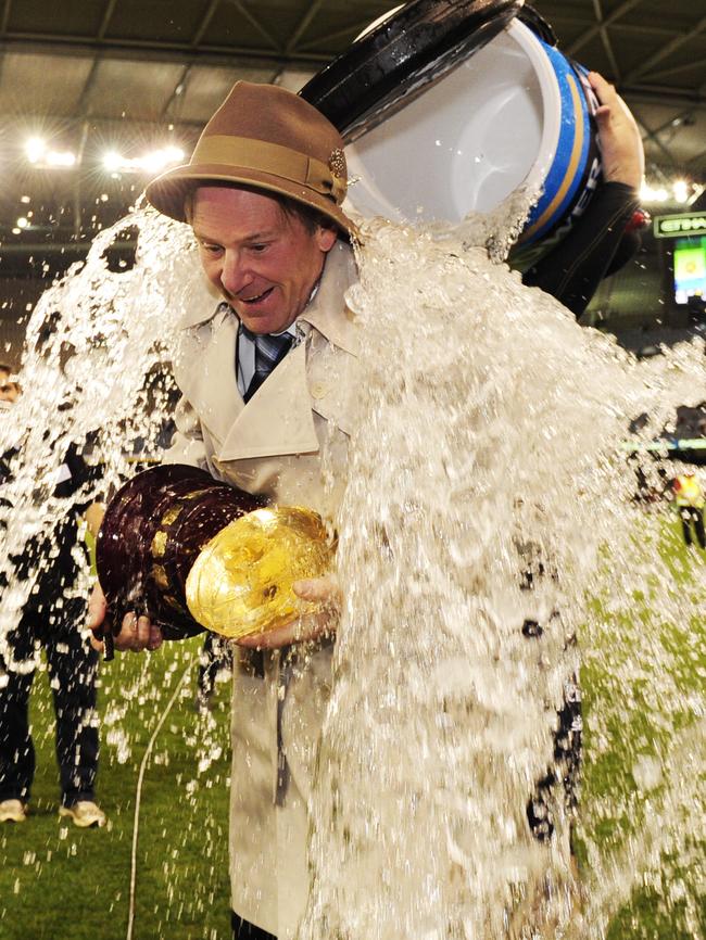 Coach Sam Newman gets drenched after the match