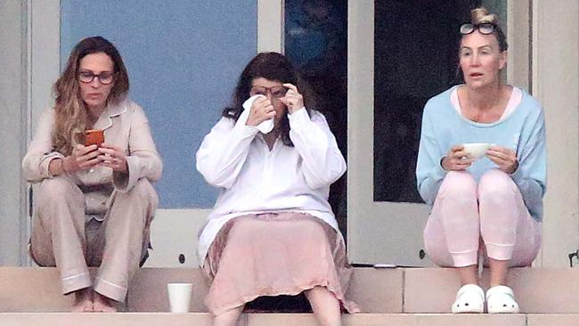 Roberts (left) sat with two members of her entourage on the back steps of the Vaucluse home. Picture: Matrix Media