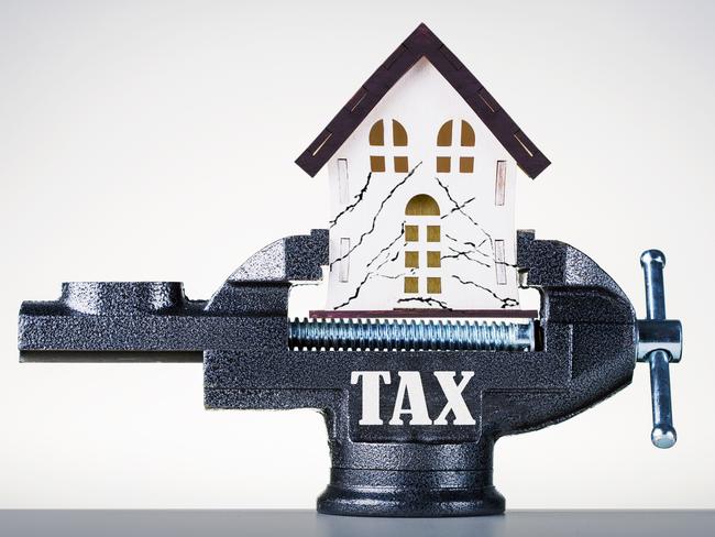 Mortgage, Tax Pressure. Clamped Miniature House In Vise; housing property tax