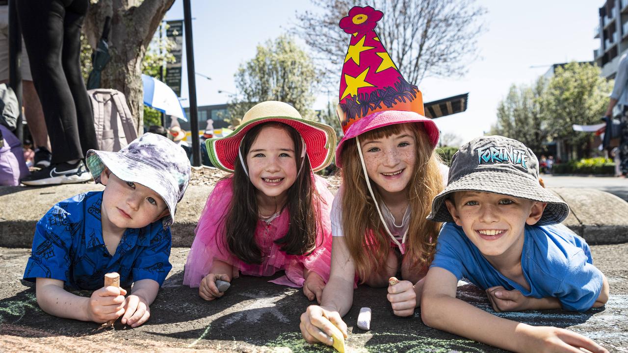 Chalk drawing are (from left) Otis Platen, Harriet Reich, Violet Platen and Trey Stephenson-Platen at the Grand Central Floral Parade of the Carnival of Flowers, Saturday, September 21, 2024. Picture: Kevin Farmer