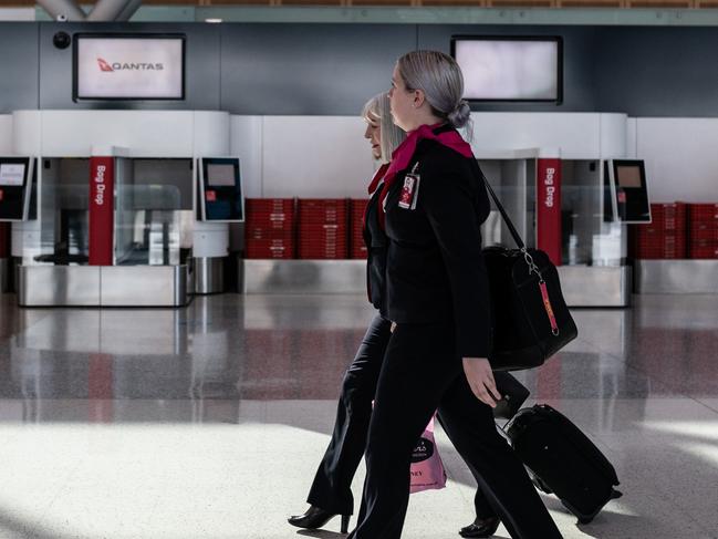 Aircrew walking through the Qantas Terminal at Sydney Airport, Sydney, Friday, June 19, 2020. Qantas Group chief executive Alan Joyce says almost 400,000 seats have been sold on Qantas and JetstarÃ¢â¬â¢s domestic networks in the past two weeks, after some state borders opened. (AAP Image/James Gourley) NO ARCHIVING