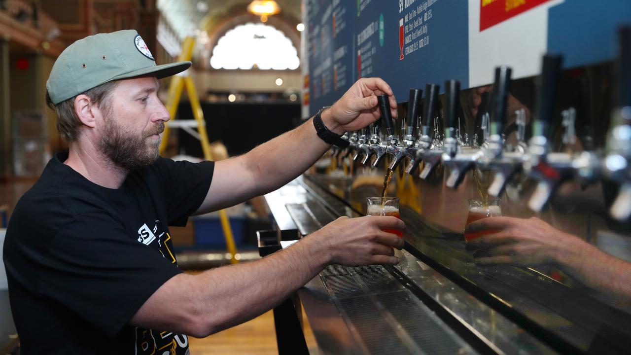 David Ozgood sets up the many taps that poured hundreds of different beers at the GABS festival in Melbourne last month. Picture: NCA NewsWire / David Crosling