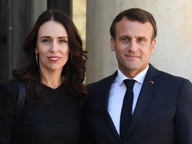 (FILES) In this file photo taken on May 15, 2019 New Zealand's Prime Minister Jacinda Ardern (L) is welcomed by French President Emmanuel Macron at the Elysee Palace in Paris on May 15, 2019, for the launch the global "Christchurch Call" initiative to tackle the spread of extremism online. - French President Emmanuel Macron and New Zealand Prime Minister Jacinda Ardern welcomed "progress made" in the fight against "online terrorist and violent extremist content" since the launch a year ago of the "Appeal of Christchurch". (Photo by Alain JOCARD / AFP)