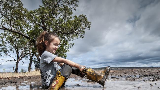 Paul Fuhlbohm’s daughter Erin enjoys the aftermath of overnight rain at Felton. Picture: David Martinelli