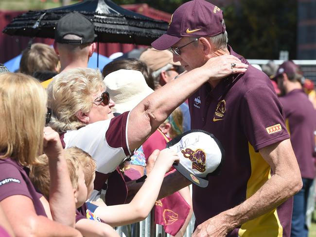 Broncos coach Wayne Bennett receives a hug from a fan during the teams return to the Brisbane Broncos Leagues Club in Brisbane, Monday, Oct. 5, 2015. The Broncos lost their NRL Grand Final match to the North Queensland Cowboys. (AAP Image/Dave Hunt) NO ARCHIVING