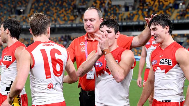 John Longmire celebrates with his young Swans after their Round 1 win. Picture: Getty Images