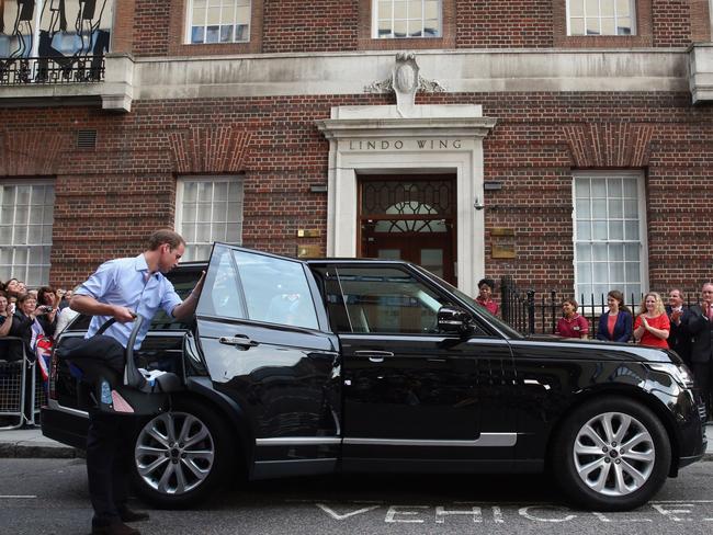 Prince William was forced to wrangle with a car seat in front of photographers following the birth of Prince George. Picture: Oli Scarff/Getty Images.