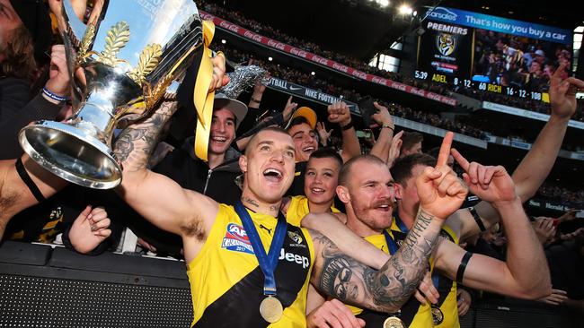 Dustin Martin holds the premiership cup as he celebrates with Tigers fans. Picture: Phil Hillyard