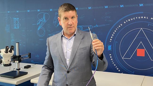 Anteris CEO Wayne Paterson holds a catheter used for inserting the valve.