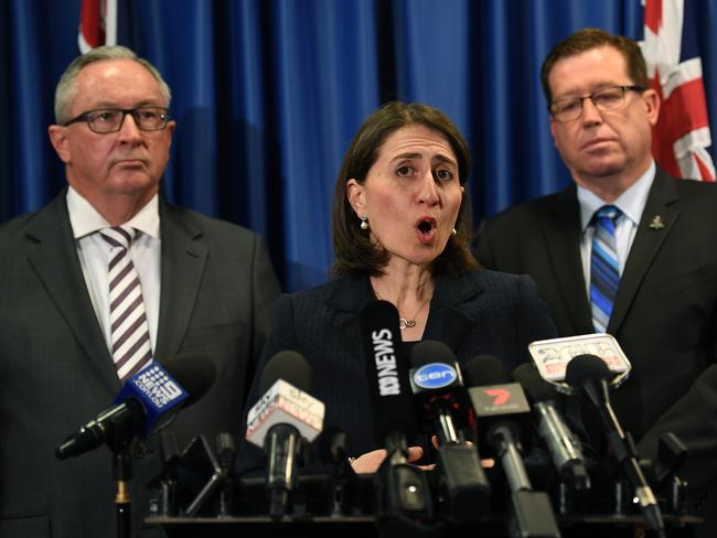 The Premier with Health Minister Brad Hazzard and Police Minister Troy Grant today. Picture: AAP