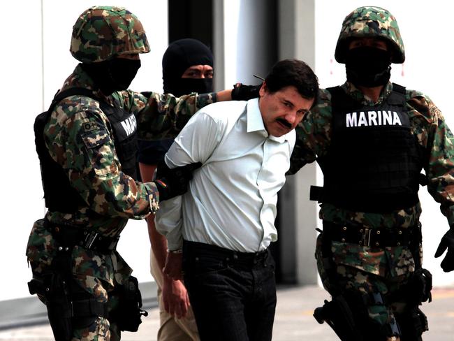 Navy soldiers escort Joaquin "El Chapo" Guzman in front of waiting media in Mexico City following his arrest in February 2014. Picture: Getty Images