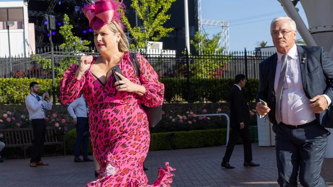 Racegoers run for the best spots trackside. Picture: Jason Edwards