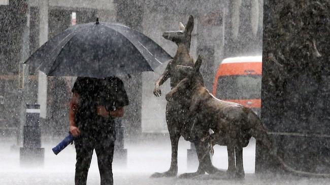 Heavy rain in Brisbane's CBD on Sunday morning. Picture: AAP/Richard Gosling