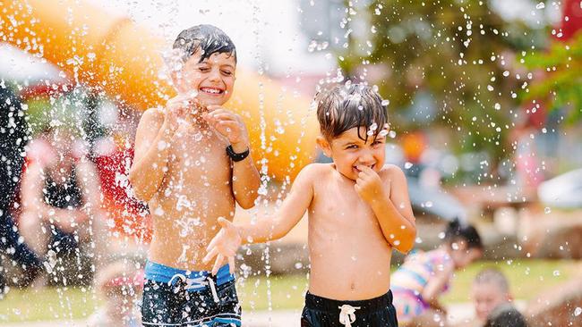 Youngsters have fun in the splash area of Hadfield Park.