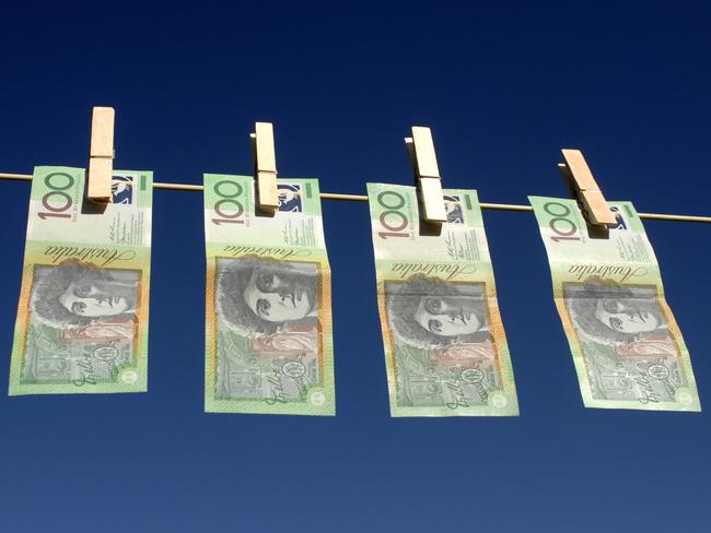 Four Australian $100.00 notes hanging on the line; Australian dollars on clothes line with peg, generic cash