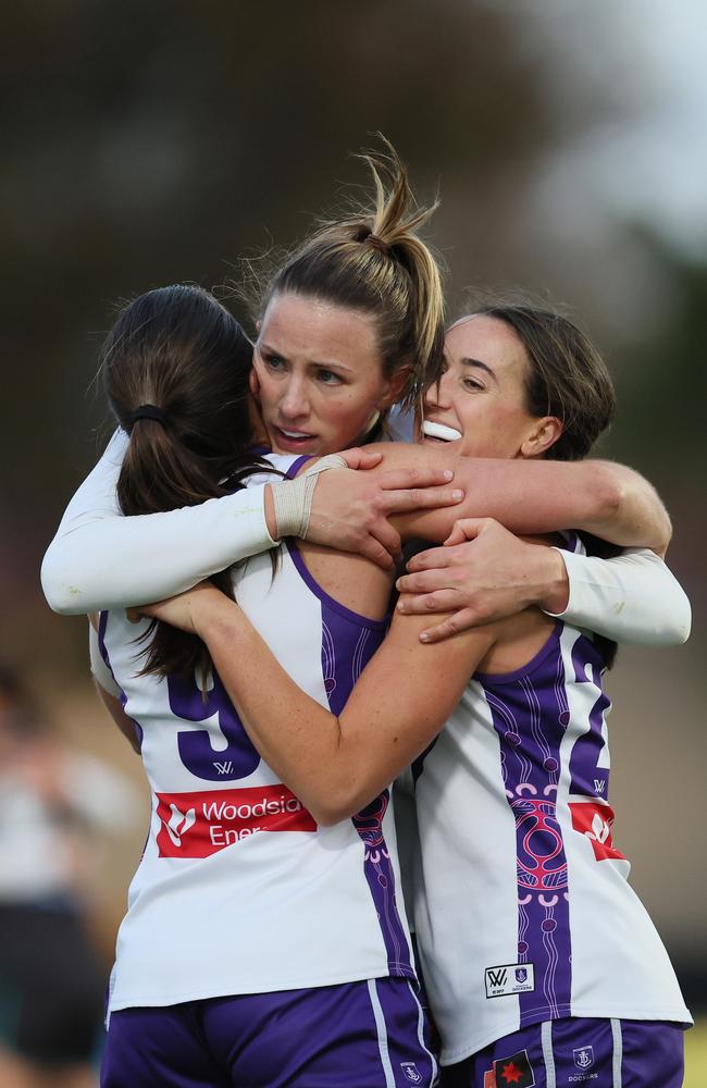 Gabby O'Sullivan, Gabrielle Newton and Airlie Runnalls of the Dockers celebrate their win over Port Adelaide. Picture: James Elsby/AFL Photos via Getty Images.