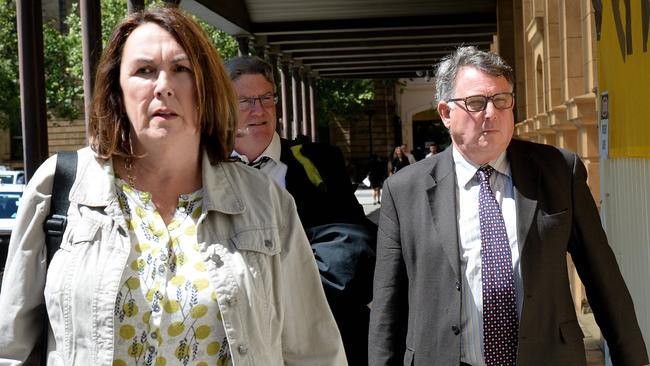 The parents – and victims – of Nicholas Chattaway leave court with their lawyer, Tony Kerin (centre). Picture: Greg Higgs.