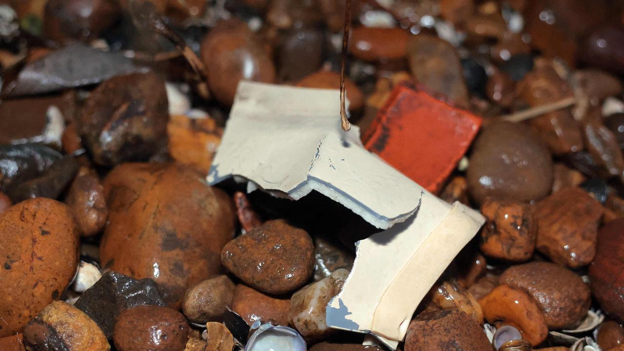 Debris is washed up on shore near the crash site of an American Airlines plane along the Potomac River.