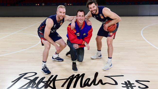 Adelaide 36ers players Brendan Teys and Kevin White with past legend Brett Maher on the new court named in his honour at the Adelaide Entertainment Centre. Picture Mark Brake