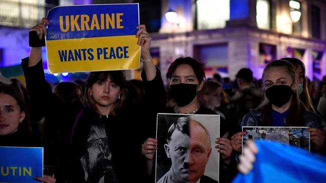 A demonstrator holds a sign depicting Adolf Hitler and Russia's president Vladimir Putin during a protest against Russia's military operation in Ukraine, in Barcelona. Picture: Pau BARRENA/AFP