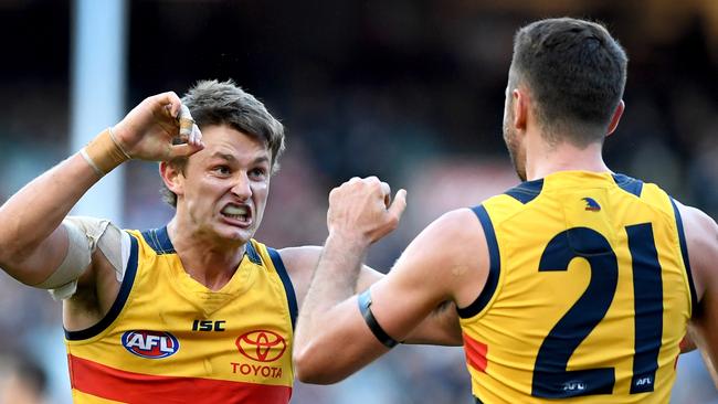 Matt Crouch celebrates with Rory Atkins after kicking a crucial goal against Carlton. Picture: Joe Castro (AAP)