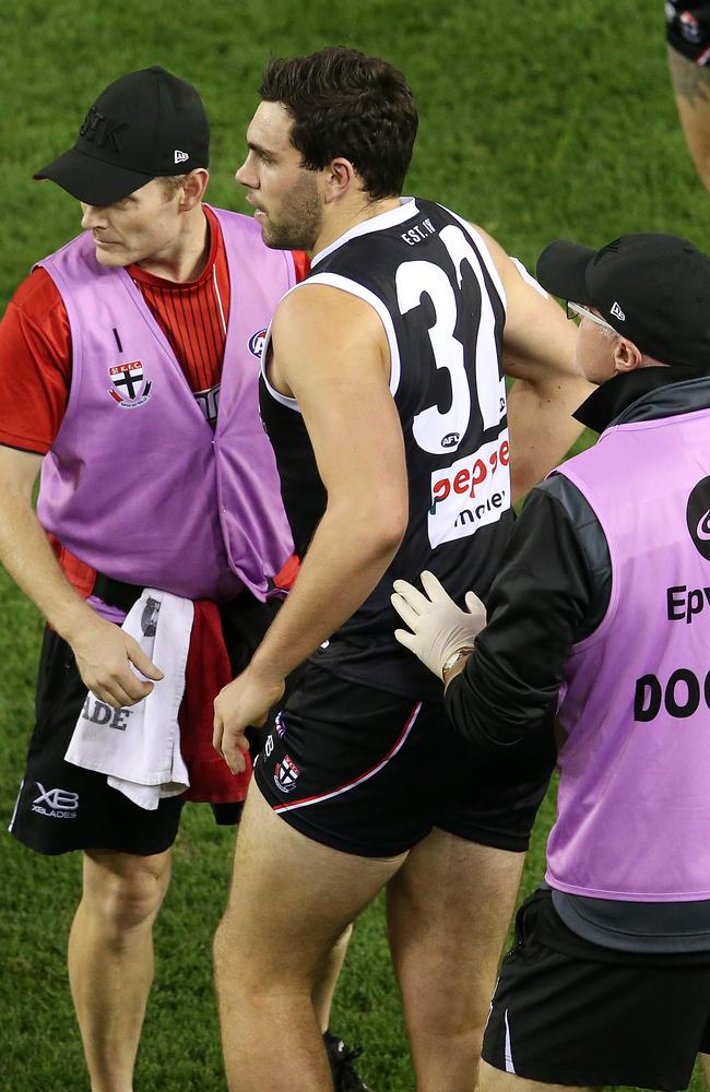 St Kilda's Paddy McCartin in the hands of doctors after colliding with Melbourne’s Neville Jetta. Picture: Michael Klein