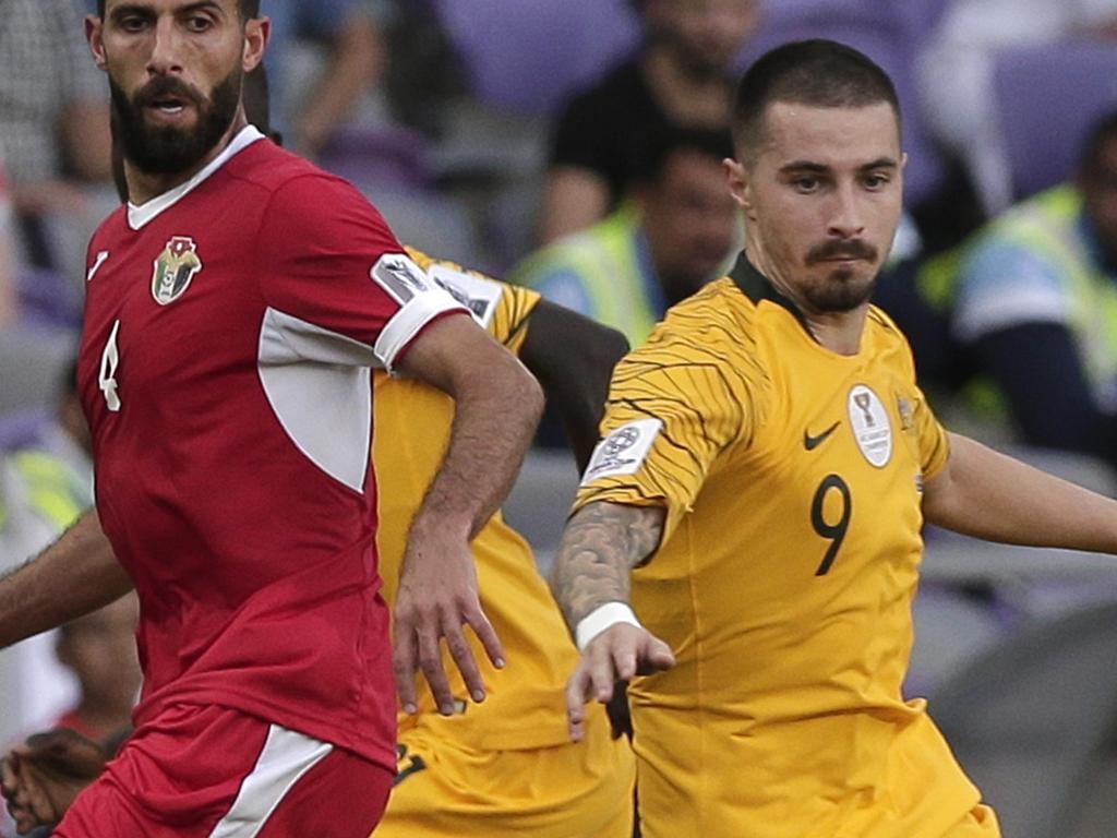 Jordan's midfielder Bahaha Abdel-Rahman, left, and Australia's forward Jamie Maclaren compete for the ball during the AFC Asian Cup group B soccer match between Australia and Jordan at the Hazza Bin Zayed stadium in Al Ain, United Arab Emirates, Sunday, Jan. 6, 2019. (AP Photo/Nariman El-Mofty)