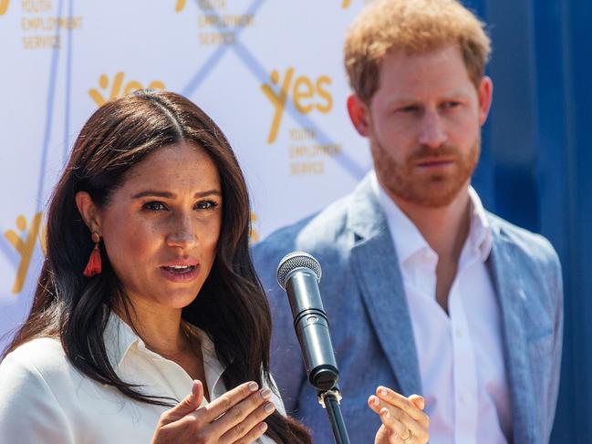 (FILES) In this file photo taken on October 2, 2019, Meghan Markle, Duchess of Sussex(L), is watched by Britain's Prince Harry, Duke of Sussex as she speaks at the Youth Employment Services Hub in Tembisa township, Johannesburg. - Markle paid tribute to George Floyd on June 4, 2020, as protests over his death in police custody sweep the nation, and expressed support for the Black Lives Matter movement. "I realized the only wrong thing to say is to say nothing because George Floydâs life mattered," Markle, who is biracial, said in a videotaped message to new graduates from her alma mater in Los Angeles, Immaculate Heart High School. (Photo by Michele Spatari / AFP)