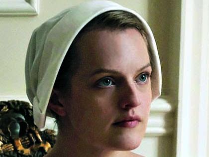 TWAM-20170805 EMBARGO FOR TWAM 5 AUG 2017This image released by Hulu shows Elisabeth Moss as Offred in a scene from, "The Handmaid's Tale." The program was nominated for an Emmy Award for outstanding drama series on Thursday, July 13, 2017. The Emmy Awards ceremony, airing Sept. 17 on CBS, will be hosted by Stephen Colbert. (George Kraychyk/Hulu via AP)