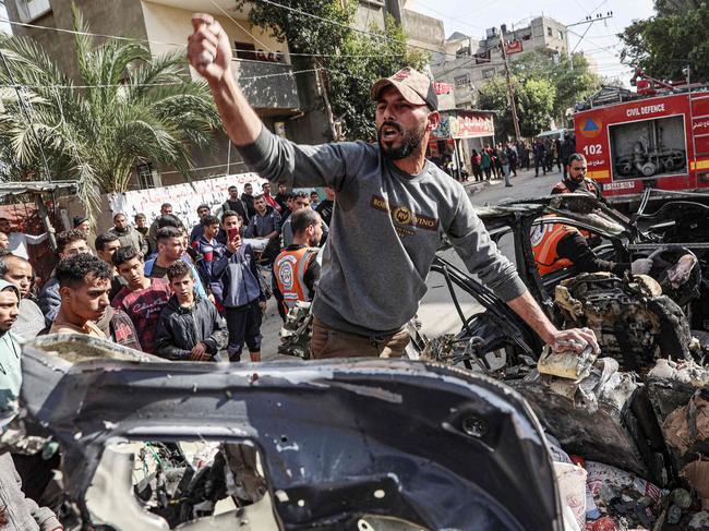 A Palestinian man inspects a car wreck following reported Israeli bombardment in Rafah in the southern Gaza Strip on January 8, 2024 amid continuing battles between Israel and the militant group Hamas. Picture: AFP