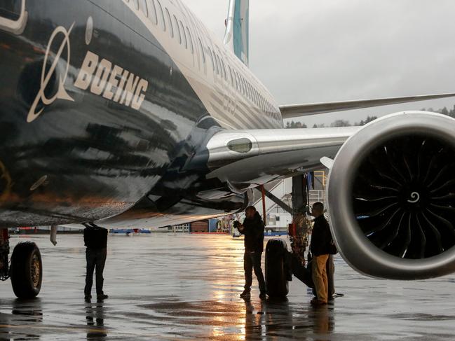 FILES) In this file photograph taken on December 8, 2015, engineers look at Boeing's 737 MAX aircraft  