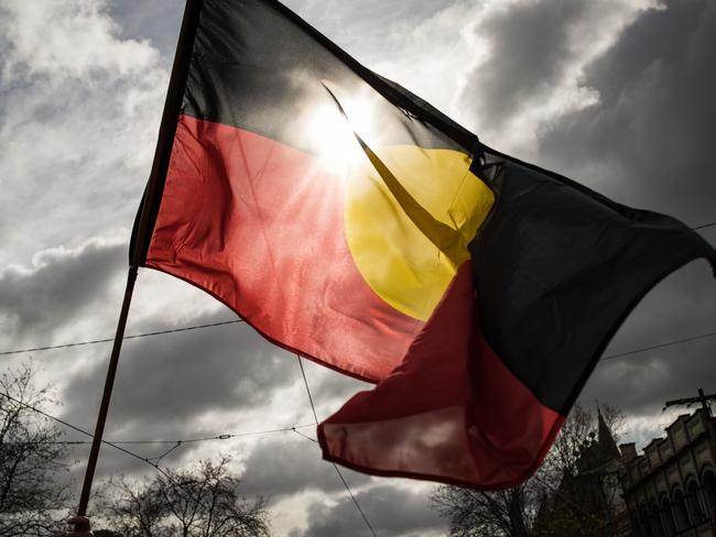 MELBOURNE, AUSTRALIA - JULY 07: The Aboriginal flag is seen flying during the NAIDOC March on July 07, 2023 in Melbourne, Australia. NAIDOC Week is an Australian observance lasting from the first Sunday in July until the following Sunday. The acronym NAIDOC stands for National Aborigines and Islanders Day Observance Committee. The week is intended as a time when all Australians can reflect on the rich history of the country's indigenous peoples, and learn about the cultures and histories of first nations groups. (Photo by Darrian Traynor/Getty Images)