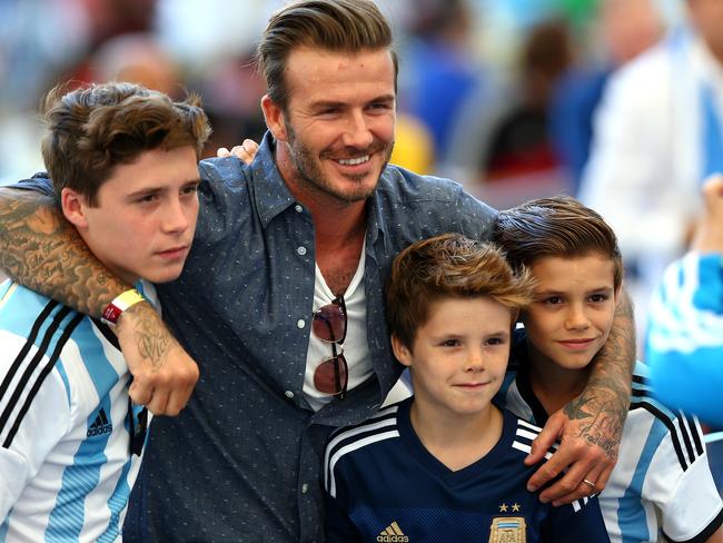 Proud papa ... David Beckham and sons Brooklyn Beckham (L), Cruz Beckham (2nd R) and Romeo Beckham (R). Picture: Getty