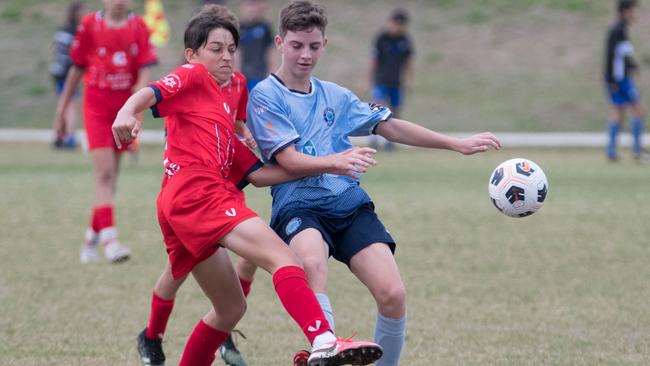 A Springfield United under-13 player battles for possession with an Olympic opponent in the Brisbane Youth Premier League South competition. Picture: Gary Reid