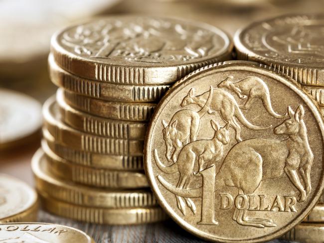 Stacks of Australian one dollar coins. Focus on front coin.