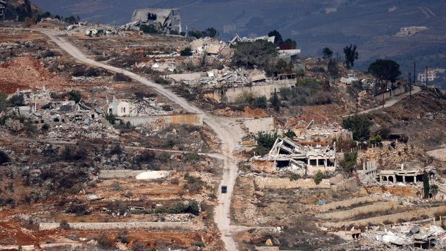 Israel's northern border with Lebanon, shows Israeli soldiers driving an quad vehicle amid the destruction in Odaisseh. Picture: AFP