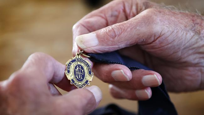 St Kilda legend Neil Roberts holds his 1958 Brownlow Medal before the club’s 150th year anniversary this weekend. Picture: Michael Klein