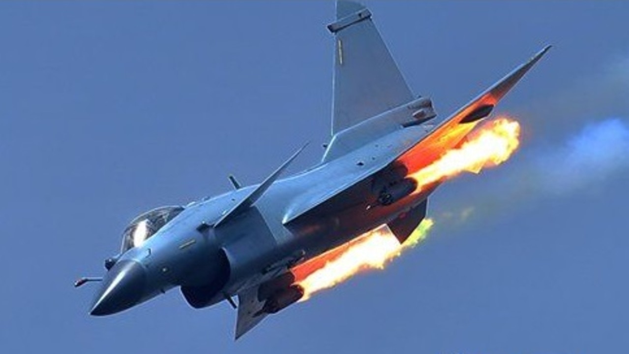 A Chinese J-11 fighter jet practices firing rockets at a weapons range