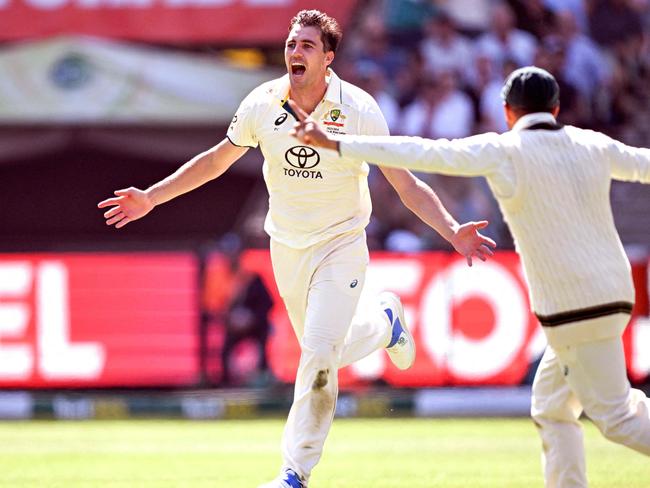 Pat Cummins celebrates removing Babar Azam. Picture: William West.