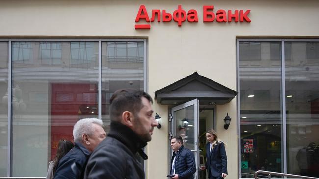 Pedestrians walk past the branch of Alfa Bank, Russia's largest private bank, in Moscow. Picture: AFP