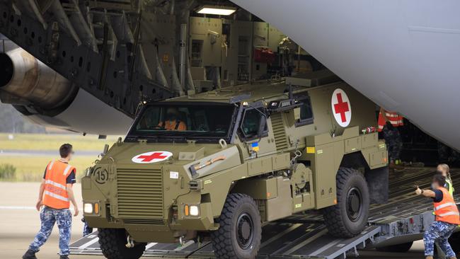 Royal Australian Air Force air movements operators from No. 23 Squadron, load a Bushmaster Protected Mobility Vehicle bound for Ukraine onto a C-17A Globemaster III aircraft, at RAAF Base Amberley, Queensland. *** Local Caption *** The Australian Government has provided further support to the Government of Ukraine by gifting 20 Bushmaster Protected Mobility Vehicles, including two ambulance variants, to aid the Government of Ukraineâs response to Russiaâs unrelenting and illegal aggression.  Australiaâs response follows a direct request from President Zelenskyy during his address to a joint sitting of the Parliament of Australian on 31 March 2022.  The Bushmaster Protected Mobility Vehicle was built in Australia to provide protected mobility transport, safely moving soldiers to a battle area prior to dismounting for close combat. The Bushmaster Protected Mobility Vehicle is well suited to provide protection to the Ukrainian Armed Forces soldiers and Ukrainian civilians against mines and improvised explosive devices, shrapnel from artillery and small arms fire.  The vehicles have been painted olive green to suit the operating environment. Additionally, a Ukrainian flag is painted on either side with the words âUnited with Ukraineâ stencilled in English and Ukrainian to acknowledge our commitment and support to the Government and people of Ukraine. The ambulances will have the traditional red cross emblem.  The Bushmaster Protected Mobility Vehicles will be fitted with radios, a global positioning system and additional bolt-on armour increasing their protection.