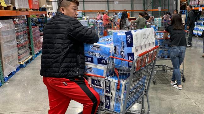 A man prepares to buy dozens of rolls of toilet paper in the US. Picture: Mark Ralston