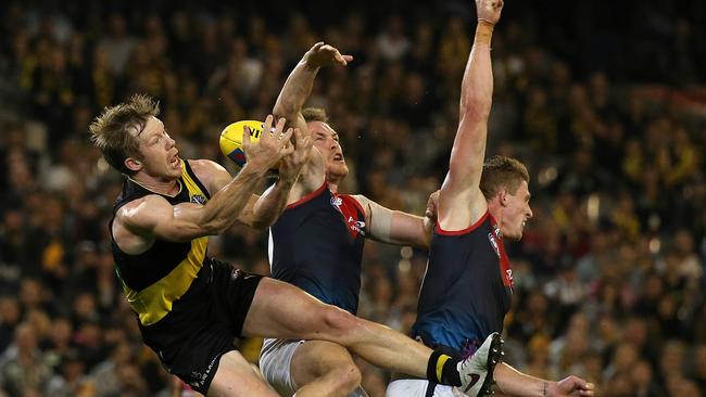 Jack Riewoldt flies over Sam Frost and Tom McDonald. Even though he spilt the mark, he still mopped up to kick a goal. Picture: Wayne Ludbey