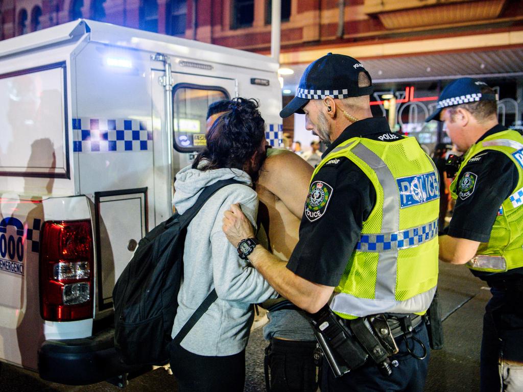 A man is consoled as he’s taken away by police in Hindley St in the early hours of 2020. Picture: AAP / Morgan Sette