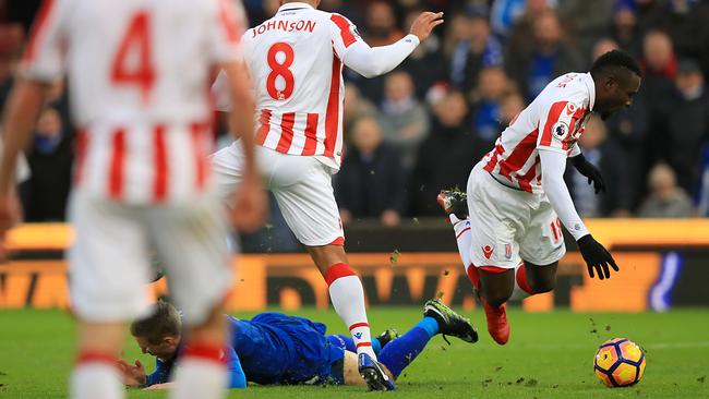 Leicester City's Jamie Vardy, below, and Stoke City's Mame Biram Diouf battle for the ball.