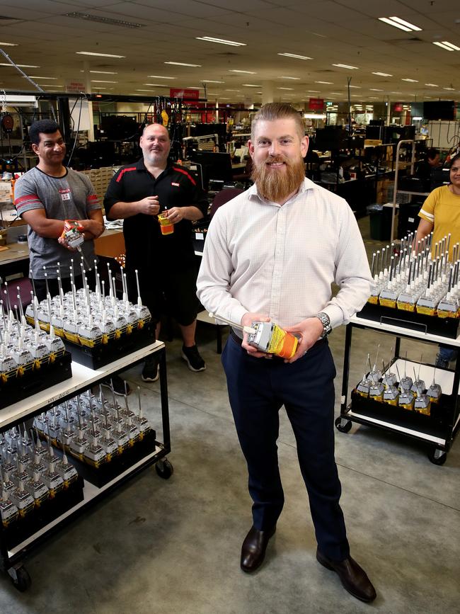 GME's head of marketing and product Tony Crooke, pictured at GME's factory in Winston Hills, NSW, where they employ over 170 people manufacturing communication equipment. Tony (C) with staff L-R Atiqullah Tahiri, Greg Adams and Latha Patil. Picture: Toby Zerna.