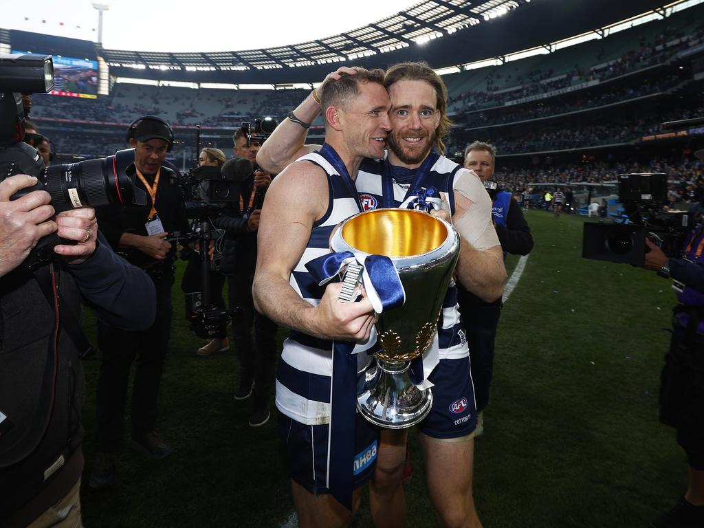 Cameron Guthrie of the Cats (R) and Joel Selwood of the Cats hold the premiership cup. Picture: Daniel Pockett