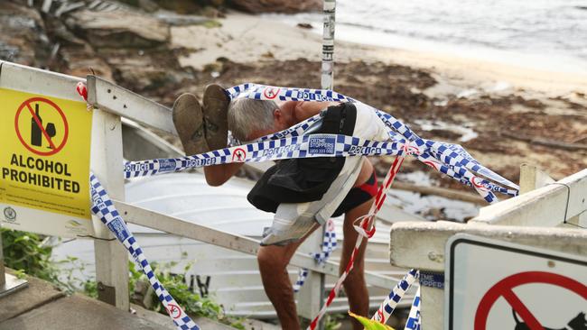 Police tape blocks the entry to Gordon’s Bay beach but people were seen climbing through to enjoy a swim. Picture John Grainger